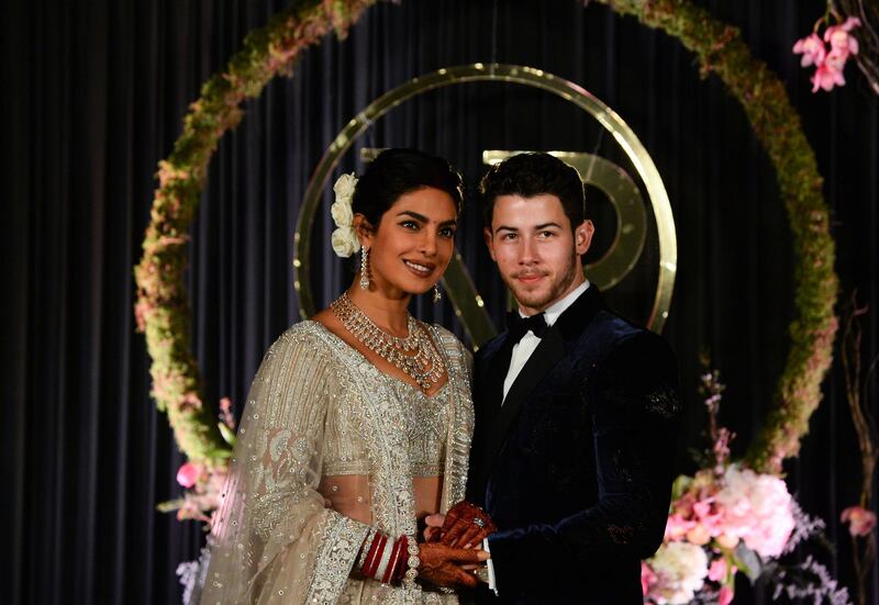 Newlyweds Priyanka Chopra, 36, and Nick Jonas, 26, pose for a photograph during a reception at a hotel in New Delhi on December 4, 2018. Photo: AFP