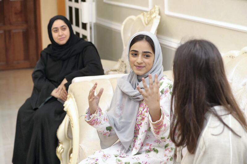 Ras al Khaimah, United Arab Emirates - May 26, 2019: Mariam Al Mansoori 11 with Denisa Fainis (R) 31 from Romania. Emirati Iftar at Hajar Al Mansouri house as part of the Emirati values iftar project led by the Federal Youth Foundation aims to educate people on traditional UAE values. the project will see Emiratis urged to host expatriates for iftar during Ramadan. Sunday the 26th of May 2019. Ras al Khaimah. Chris Whiteoak / The National
