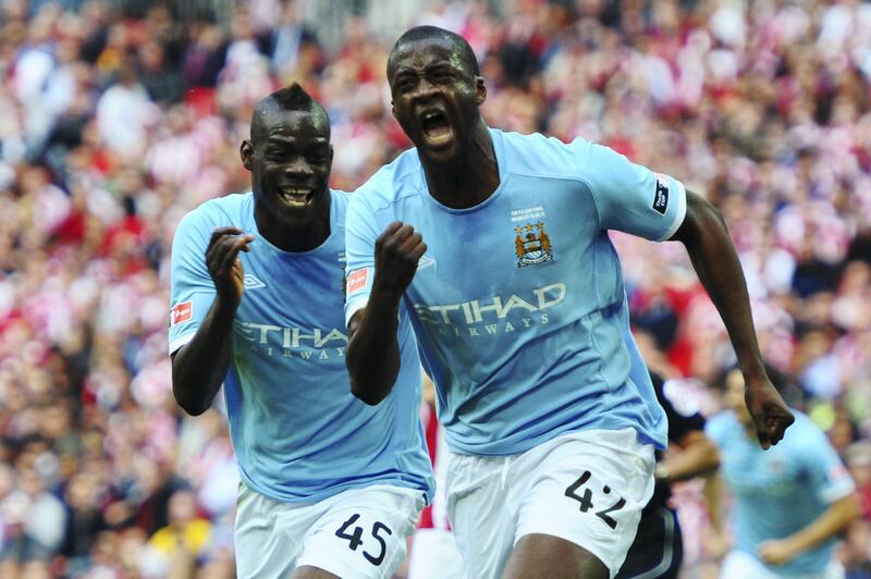 LONDON, ENGLAND - MAY 14:  Yaya Toure (R) of Manchester City celebrates with Mario Balotelli (L) after scoring during the FA Cup sponsored by E.ON Final match between Manchester City and Stoke City at Wembley Stadium on May 14, 2011 in London, England.  (Photo by Mike Hewitt/Getty Images)