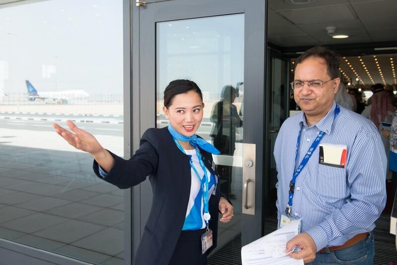 A staff directs a volunteer during the operational trial run of Al Maktoum International Airport. Courtesy Dubai Airports