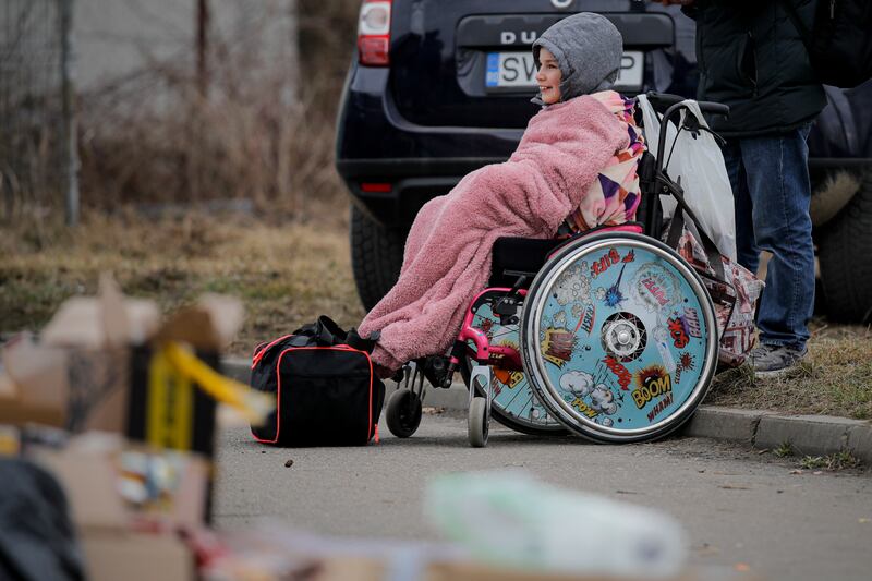 A wheelchair user who fled the conflict in Ukraine awaits transport at the Romanian-Ukrainian border in Siret. AP