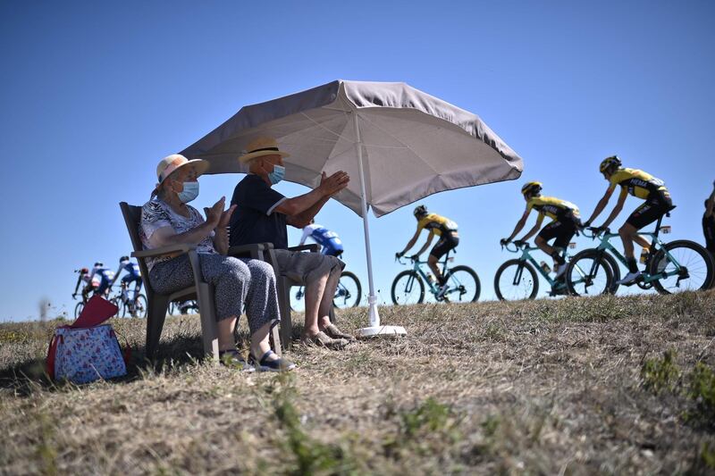 Spectators applaud the riders during Stage 11. AFP