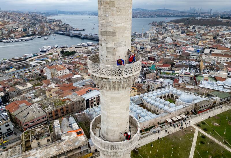 Mahya masters install lights that will spell out a message at the top of one of the Suleymaniye Mosque minarets in Istanbul, in the run-up to Ramadan. Mahya is the Turkish tradition of stringing up religious messages and designs. AP