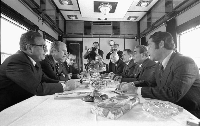 Mr Kissinger sits next to US  president Gerald Ford during discussions with Soviet leader Leonid Brezhnev and other top officials, on a Russian train headed for Vladivostok, eastern Russia, in 1974. Reuters