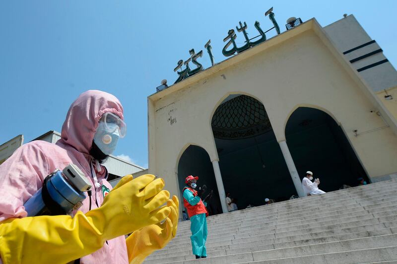 A muslim devotee wearing a protective gear offers prayers at the Baitul Mukarram National Mosque in Dhaka, Bangladesh. AFP