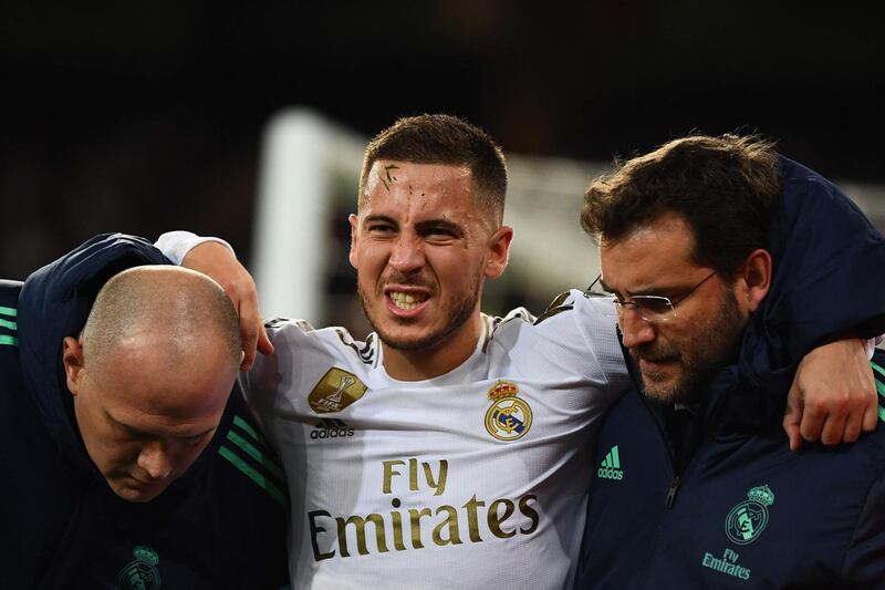 (FILES) In this file photo taken on November 26, 2019 Real Madrid's Belgian forward Eden Hazard gestures in pain during the UEFA Champions League group A football match Real Madrid against Paris Saint-Germain FC at the Santiago Bernabeu stadium in Madrid. Eden Hazard is set to miss the Clasico against Barcelona after further tests revealed a fracture in his right ankle, Real Madrid confirmed on December 5, 2019.  / AFP / GABRIEL BOUYS                    
