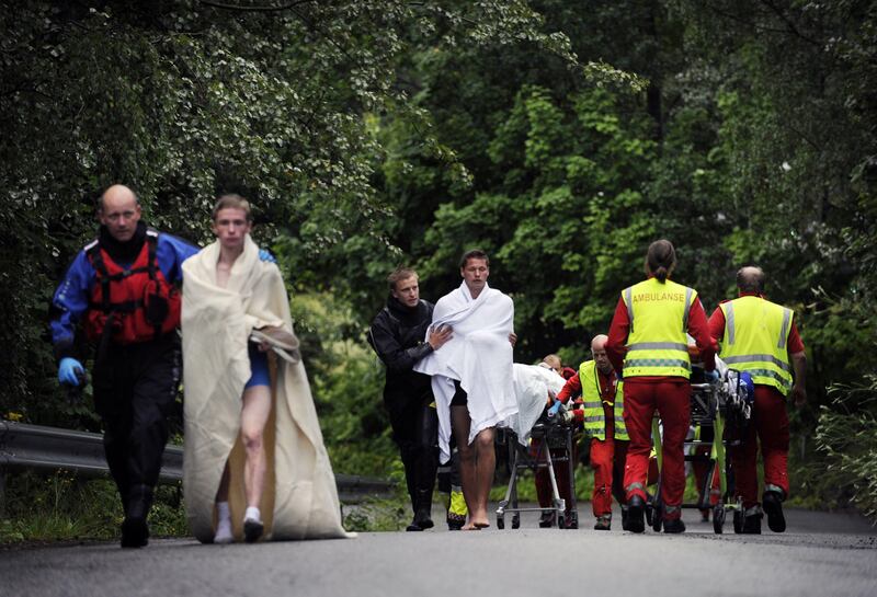 Rescue workers evacuate young people from the summer school meeting organised by the ruling Labour Party on Utoeya, an island outside the capital, on July 23, 2011.  Norwegian police on described the main suspect in twin bomb and shooting attacks that left at least 91 dead as a Christian fundamentalist. A police official said that information gleaned on the internet suggested the 32-year-old ethnic Norwegian was a "Christian fundamentalist." At least 84 people died in the shooting in Utoeya, while seven were killed when a powerful bomb ripped through central Oslo, where the prime minister's office and several government buildings are located. AFP PHOTO / SCANPIX - MORTEN EDVARSEN = NORWAY OUT
 *** Local Caption ***  476191-01-08.jpg