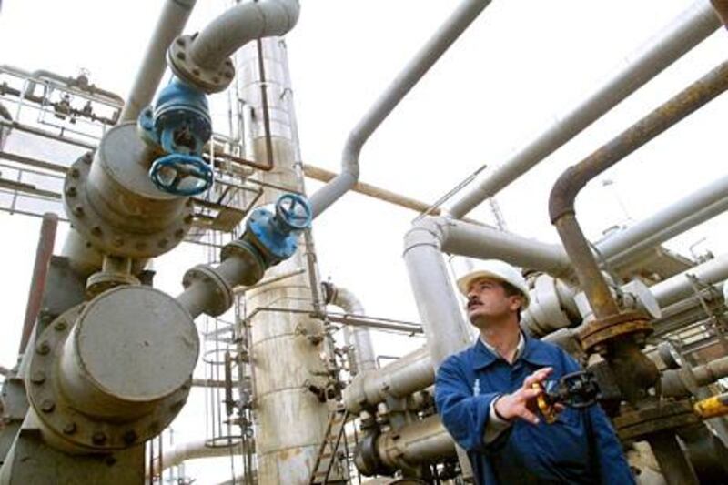 An Iraqi Kurd works at the only oil refinery in Kurdistan, which was built in 1997, in the Patriotic Union of Kurdistan (PUK)-controlled city of Suleimaniya, some 250 kms northeast of Baghdad, 12 March 2003. Opposition officials based in the Kurdish rebel-held north acknowledged that informal negotiations have been underway with a number of multinational oil giants, who are working on the assumption that any old contracts signed with baghdad will soon be declared null and void. The Kurdish factions are expected to wield power in Kirkuk and Mosul, where one-third of Iraq's oil is tapped. AFP PHOTO/Behrouz MEHRI