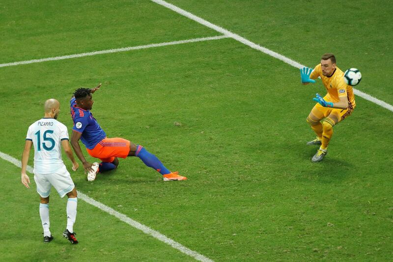 Colombia substitute Duvan Zapata, second left, scores against Argentina goalkeeper Franco Armani. EPA