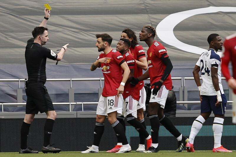 Manchester United's Edinson Cavani, centre, partly hidden, is booked by referee Chris Kavanagh. EPA