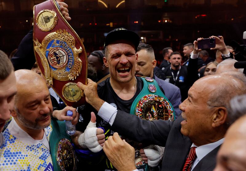 Oleksandr Usyk celebrates with the belts after beating Tyson Fury to become the undisputed heavyweight world champion in Riyadh, Saudi Arabia, on May 18, 2024. Reuters