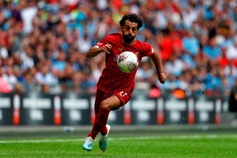 Mohamed Salah runs with the ball during the first half. AFP