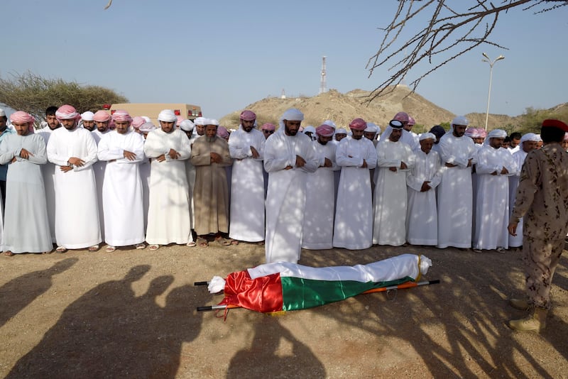 Friends and family of Warrant Officer Mohammed Saeed Al Hassani perform funeral prayes before burial in Fujairah on Saturday.