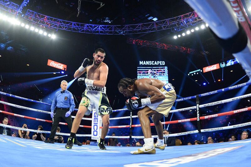 Javier Molina (gray/black/green trunks) and Amir Imam (gold/white trunks) box during their super lightweight bout at MGM Grand Garden Arena, Las Vegas.  Reuters