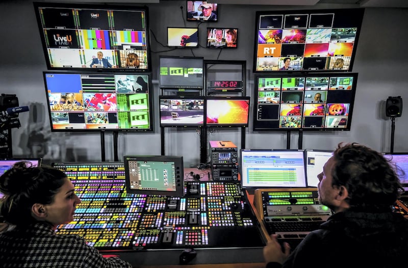 A picture taken on June 8, 2018 shows an unidentified directors of the Russia Today (RT) TV company at in their apparatus room in Moscow. (Photo by Yuri KADOBNOV / AFP)