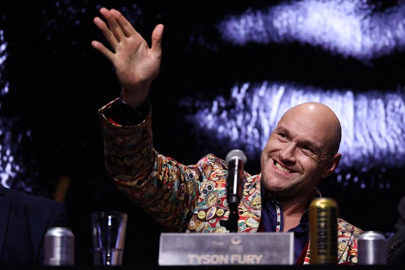 Tyson Fury waves to attendees during the press conference. AFP