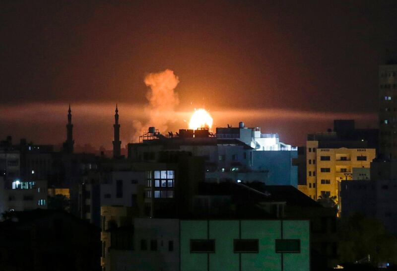 An explosion is seen in Gaza city after an airstrike by Israeli forces on June 2, 2018. / AFP / Mahmud Hams
