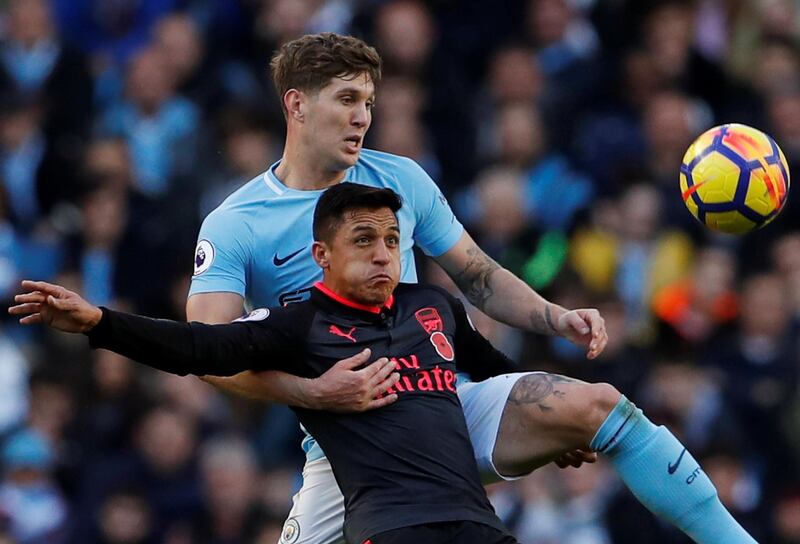 Soccer Football - Premier League - Manchester City vs Arsenal - Etihad Stadium, Manchester, Britain - November 5, 2017   Manchester City's John Stones in action with Arsenal's Alexis Sanchez   Action Images via Reuters/Lee Smith  EDITORIAL USE ONLY. No use with unauthorized audio, video, data, fixture lists, club/league logos or "live" services. Online in-match use limited to 75 images, no video emulation. No use in betting, games or single club/league/player publications. Please contact your account representative for further details.
