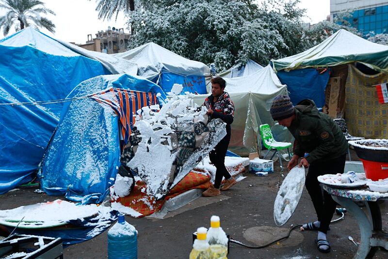 Fresh snow falls in Tahrir Square while anti-government protesters stage a sit-in, Baghdad, Iraq. AP Photo