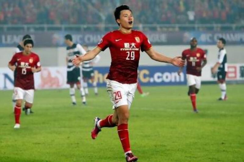 Gao Lin, centre, celebrates after scoring a goal against Thailand's Muangthong United for China's Guangzhou Evergrande in their Group F match of the Asian Champions League.