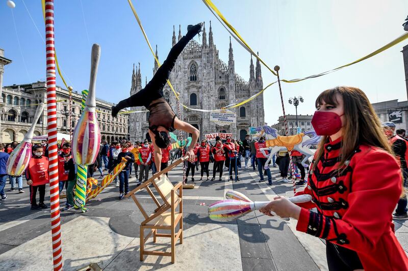 Circus artists perform in front of the Duomo gothic cathedral during a demonstration by circus workers demanding more support from the Italian government, in Milan, northern Italy. AP Photo