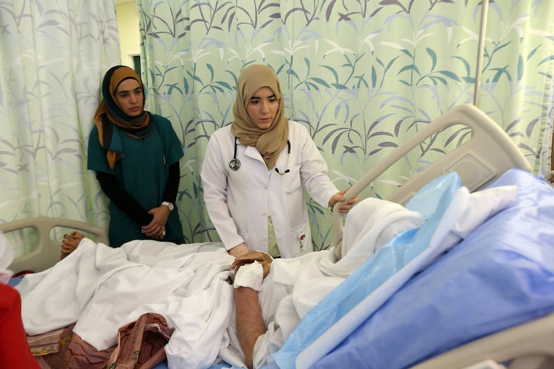 AJMAN , UNITED ARAB EMIRATES Ð June 15 , 2014 : Hessa Ali , Emirati trainee doctor ( center ) talking to the patient at Khalifa hospital in Ajman. ( Pawan Singh / The National ) For News. Story by Melanie Swan

