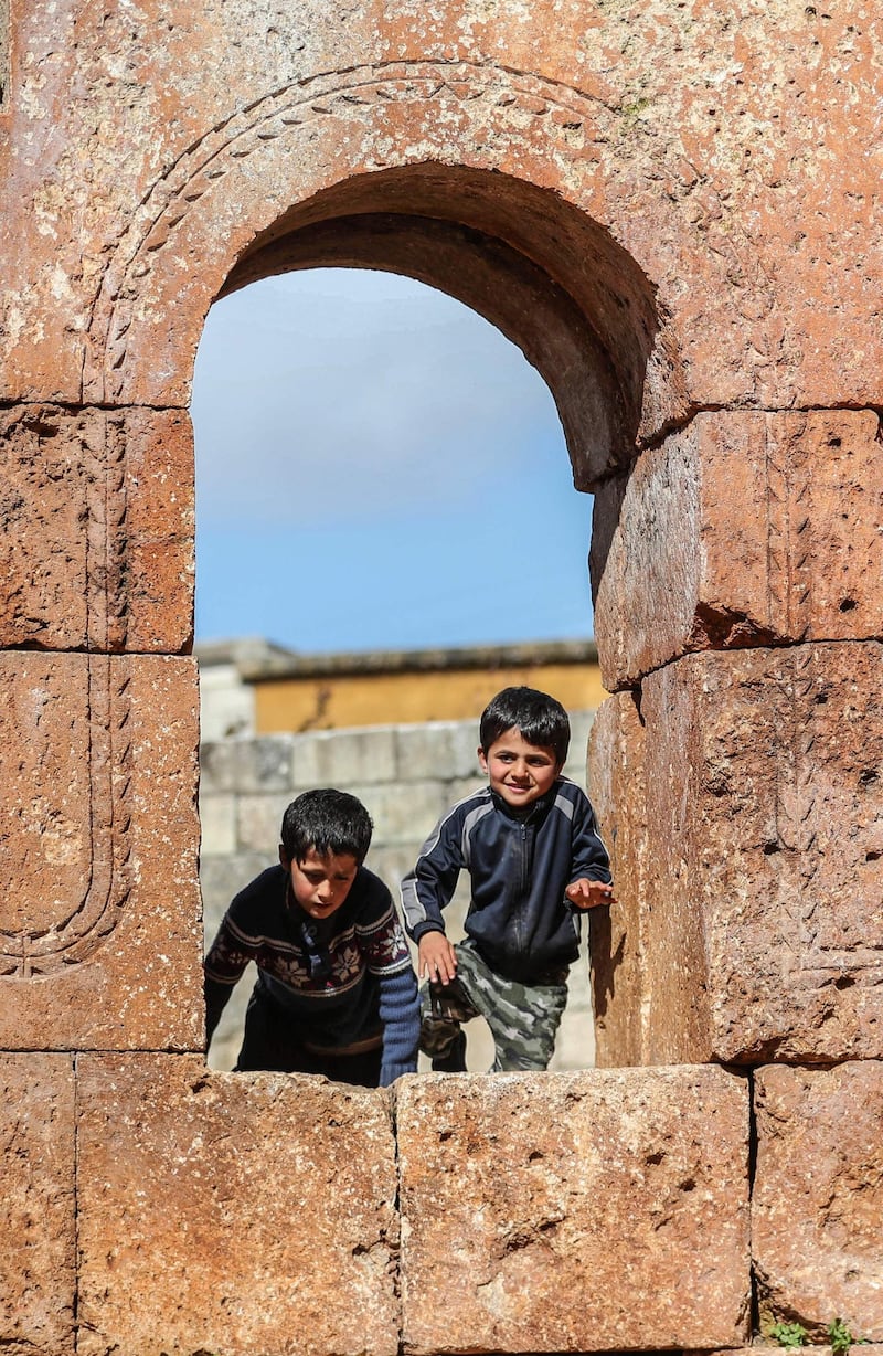 Children sit on one of the apse's windows. AFP