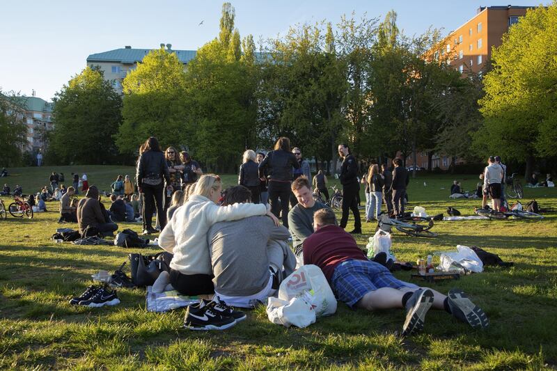 Groups of people sit in a park at Tantolunden in Stockholm, Sweden, on Friday, May 22, 2020. Sweden, which has refused to close down schools and restaurants to contain the new coronavirus, is being closely watched as many other countries are gradually opening up their economies from stricter lockdowns. Photographer: Loulou D'Aki/Bloomberg