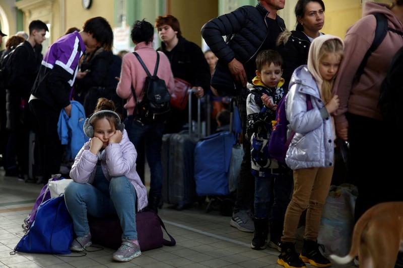 Ukrainian refugees rest in the ticket hall of Przemysl Glowny train station. Reuters