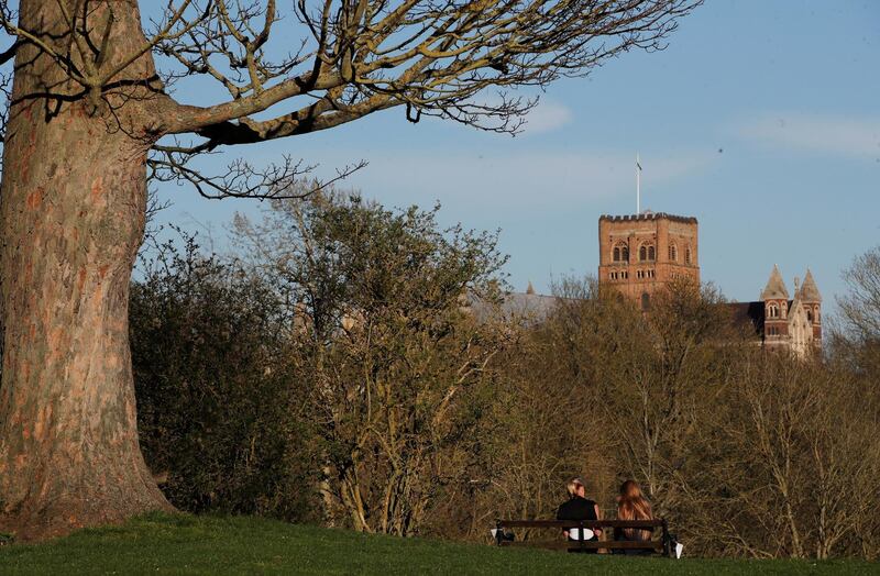 Two women sitting on a bench in Verulamium Park, as the spread of the coronavirus disease (COVID-19) continues, in St Albans, Britain, March 25, 2020. REUTERS/Paul Childs