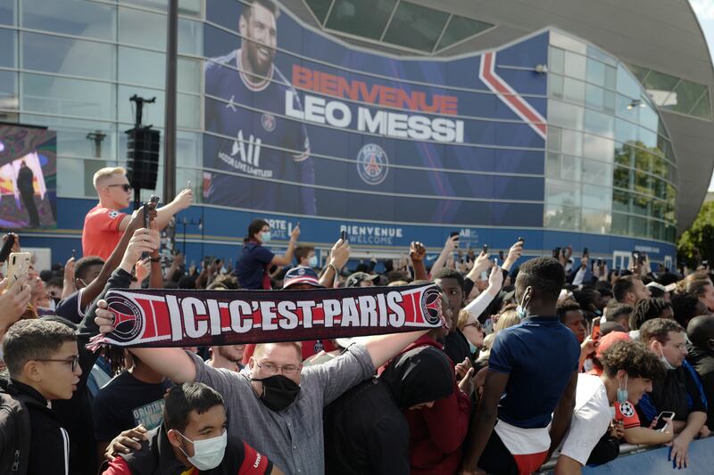 Paris Saint-Germain supporters gather outside the Parc des Princes before Lionel Messi's press conference.