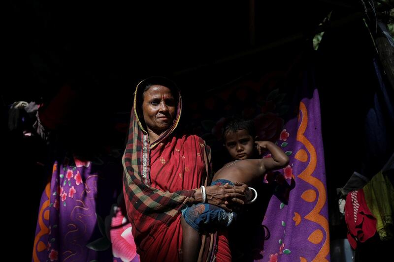 A Rohingya Hindu refugee poses for a picture in front of her temporary shelter at the Kutupalong Hindu refugee camp near Cox's Bazar, Bangladesh December 17, 2017. REUTERS/Marko Djurica