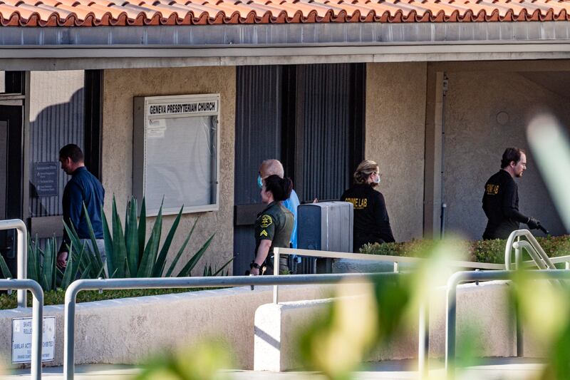 Investigators walk outside the Geneva Presbyterian Church. AP