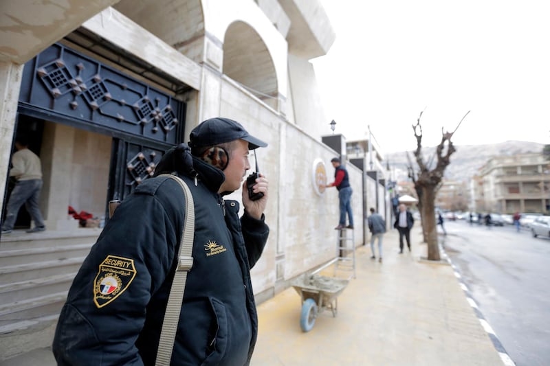 Security stand guard outside theUAE embassy building during the inauguration ceremony of the reopening of the embassy in Damascus, Syria. EPA