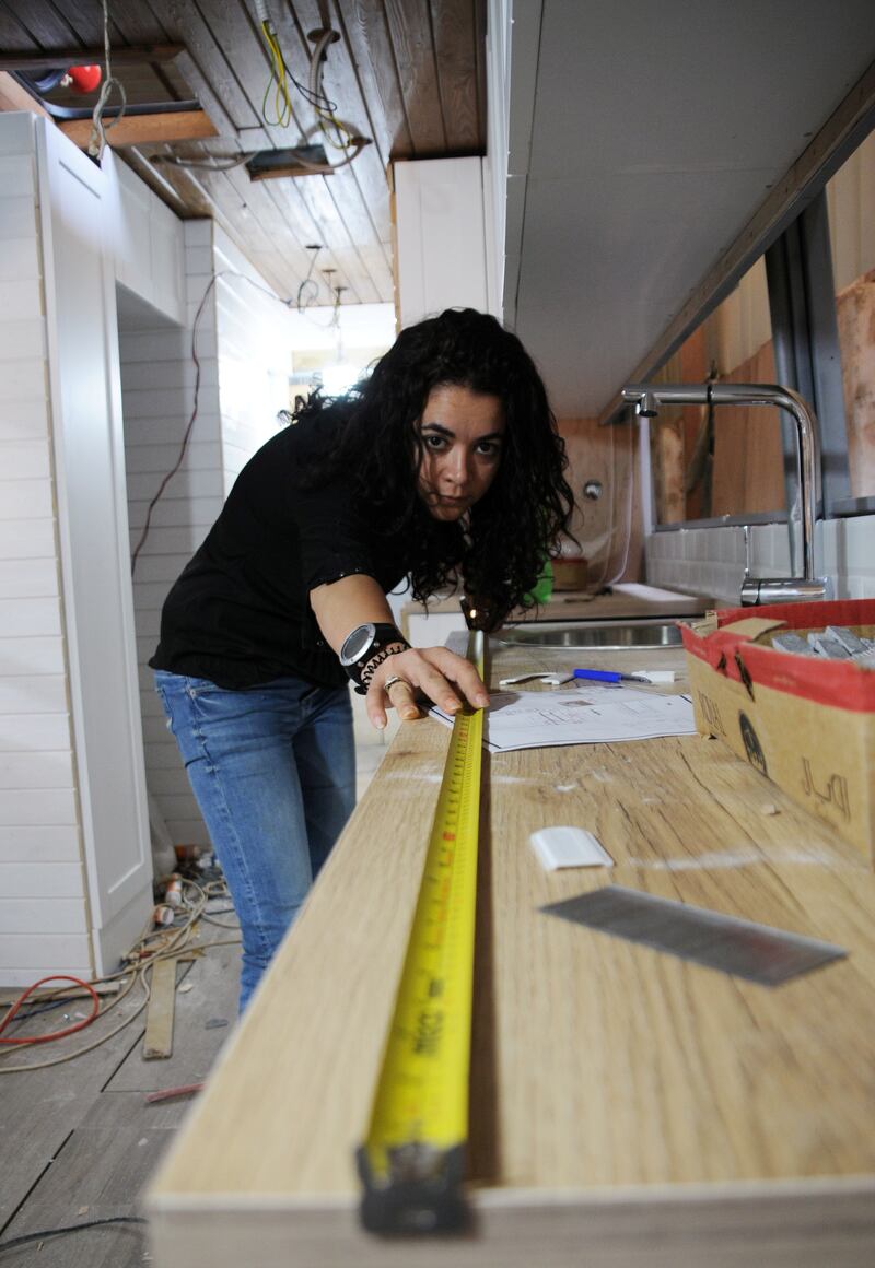 Yara Shalabi works on converting the coach into a home.