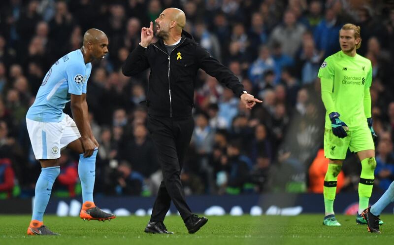 Pep Guardiola gestures as he walks with his players towards the tunnel at half time. Anthony Devlin / AFP