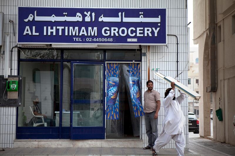 Abu Dhabi, United Arab Emirates, January 10, 2013: 
Men clear out shelving from the Al Ihtimam Grocery, a recently closed convenience store on Thursday, Jan. 10, 2013, in the city block between Airport and Muroor, and Delma and Mohamed Bin Khalifa streets in Abu Dhabi. 
Silvia Razgova/The National

