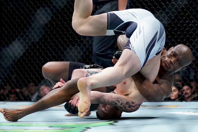 Kamaru Usman, right, grapples with Colby Covington. AP Photo