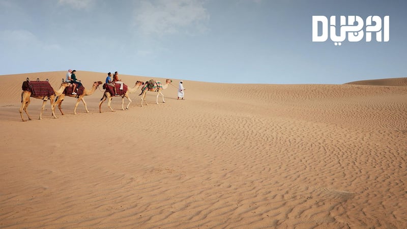 Camel riding in the desert. Courtesy Dubai Tourism