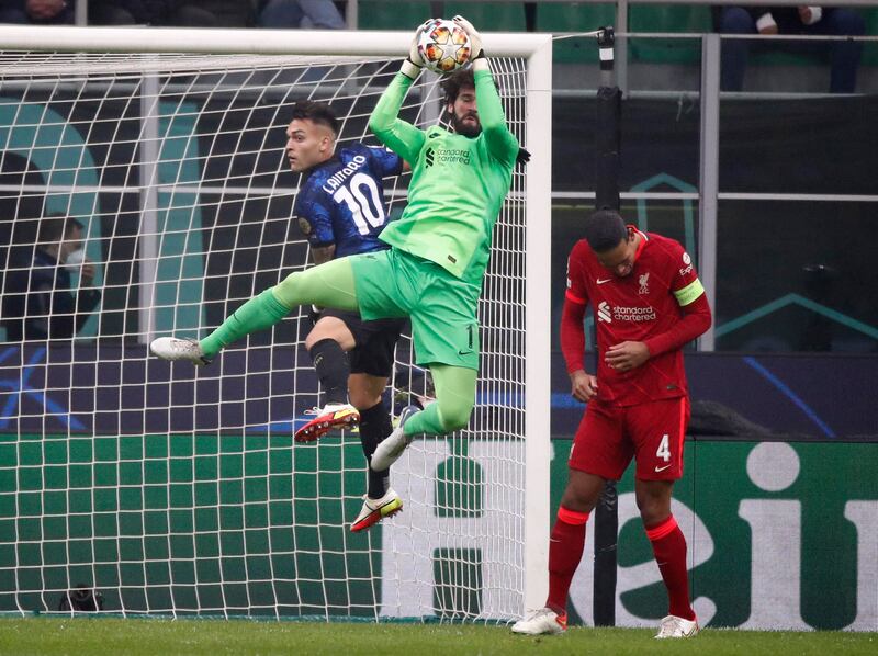 Inter's Lautaro Martinez challenges Liverpool keeper Alisson. Reuters