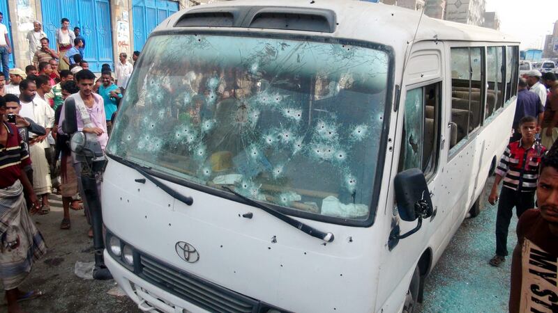 Yemenis gather around a bullet-scarred army bus after it was attacked by suspected militants in the southern city of Aden, Yemen on June 15, 2014. At least eight people were killed and several wounded in an attack blamed on Al Qaeda gunmen. EPA