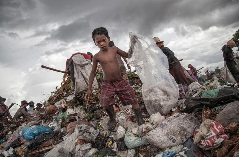 A child scavenges for food on the Anlong Pi rubbish dump, Siem Reap, Cambodia – a country where a third of the population lives in extreme poverty , on less than $1 a day. Getty Images