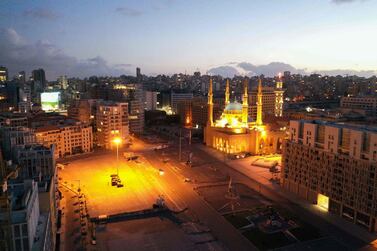 An aerial view shows Beirut's Martyrs Square deserted during a nighttime curfew. Lebanon, which is going through an economic crisis, recorded a sharpest deterioration in business conditions. AFP