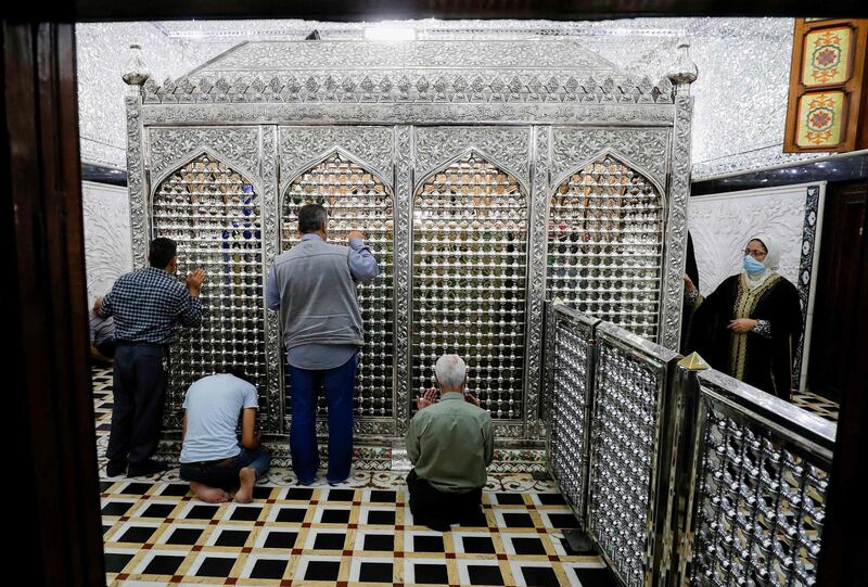 Iraqi men pray at the shrine of Abdel Kader Gilani in central Baghdad, during the month of Ramadan. AFP