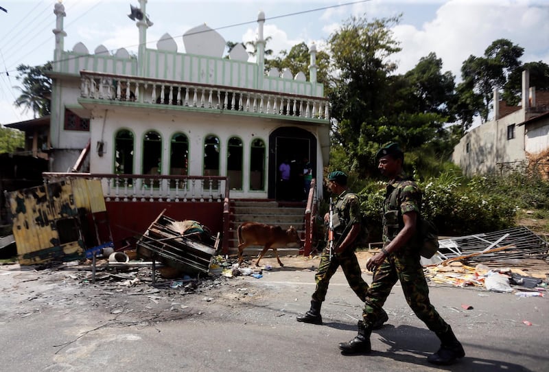 Sri Lanka's Special Task Force soldiers walk past a damaged mosque after a clash between two communities in Digana central district of Kandy, Sri Lanka March 8, 2018. REUTERS/Dinuka Liyanawatte