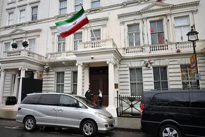 Police officers stand on duty outside the Iranian embassy in London. AFP