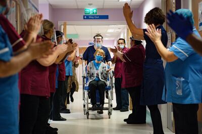 Margaret Keenan, 90, is applauded as she returns to her ward after becoming the first person in the UK to receive the Pfizer/BioNtech covid-19 vaccine. Getty Images
