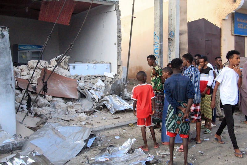 Damage to the Pearl Beach Hotel in Lido Beach, Mogadishu, draws onlookers. EPA
