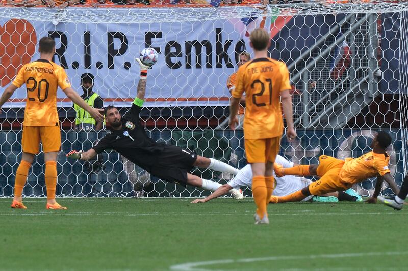 The Netherlands' Georginio Wijnaldum, right, scores his side's second goal past Italy goalkeeper Gianluigi Donnarumma. AP 