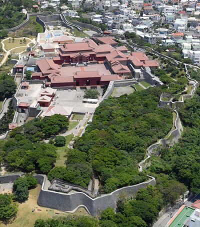 This May 2017, aerial photo shows Shuri Castle in Naha, Okinawa, southern Japan, Thursday, Oct. 31, 2019. A fire spread among structures at Shuri Castle on Thursday, Oct. 31, 2019, on Japan's southern island of Okinawa, nearly destroying the UNESCO World Heritage site. (Kyodo News via AP)
